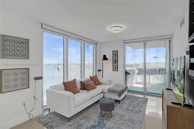 a living room with furniture wooden floor and a flat screen tv
