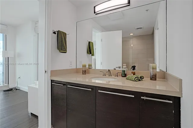 a bathroom with a double vanity sink and mirror