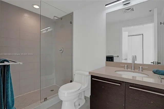 a bathroom with a sink toilet and shower