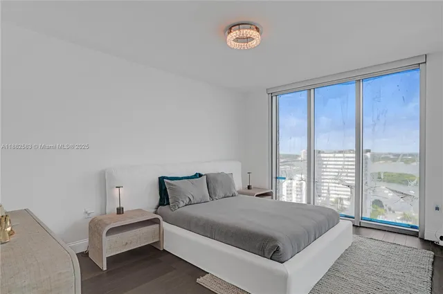 a bedroom with a large bed and a large window