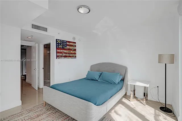 a bedroom with a bed and a night stand