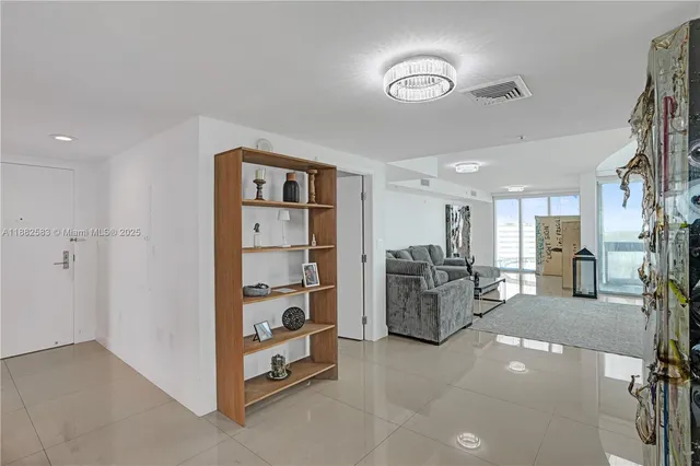 a view of a livingroom with furniture and a ceiling fan