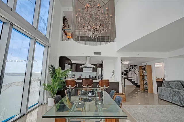 a living room with furniture and a chandelier
