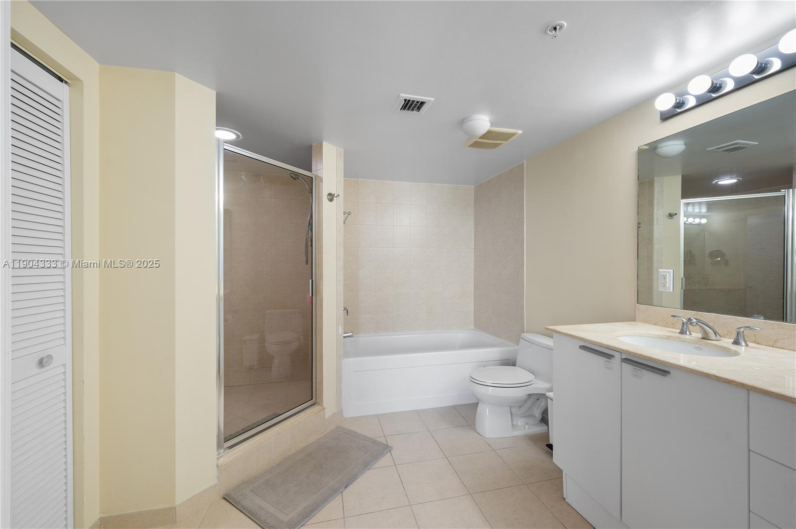 16699 Collins Avenue, Unit 3305 Sunny Isles Beach, FL 33160 - Photo 16 of 20 a bathroom with a sink a toilet and shower