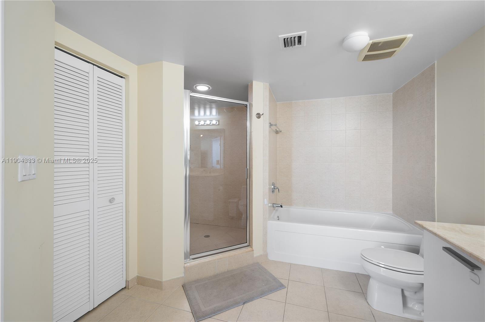 16699 Collins Avenue, Unit 3305 Sunny Isles Beach, FL 33160 - Photo 18 of 20 a bathroom with a shower a toilet and bathtub