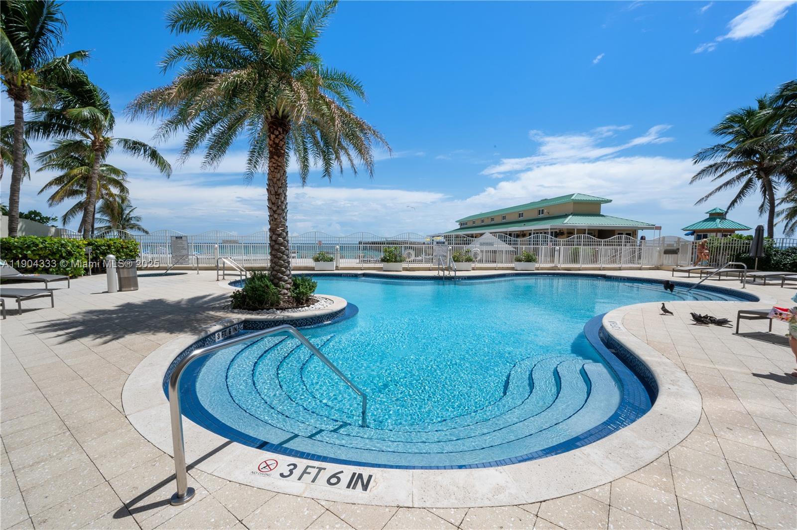 16699 Collins Avenue, Unit 3305 Sunny Isles Beach, FL 33160 - Photo 19 of 20 a swimming pool with outdoor seating
