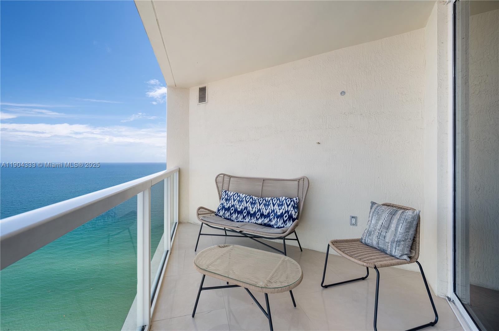 16699 Collins Avenue, Unit 3305 Sunny Isles Beach, FL 33160 - Photo 7 of 20 a view of a room with furniture and wooden floor