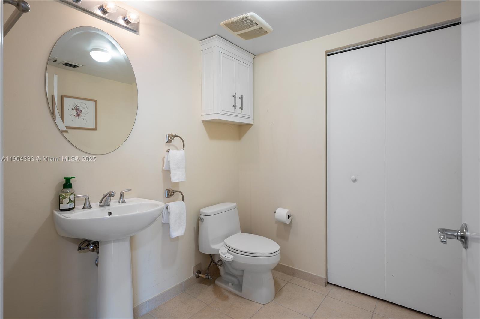16699 Collins Avenue, Unit 3305 Sunny Isles Beach, FL 33160 - Photo 10 of 20 a bathroom with a toilet sink and mirror