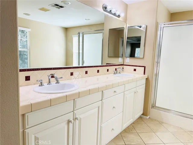 a spacious bathroom with a tub sink and mirror