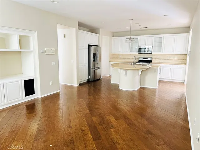 a kitchen with stainless steel appliances a refrigerator and a stove top oven
