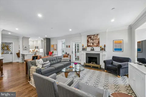 a living room with furniture fireplace and rug