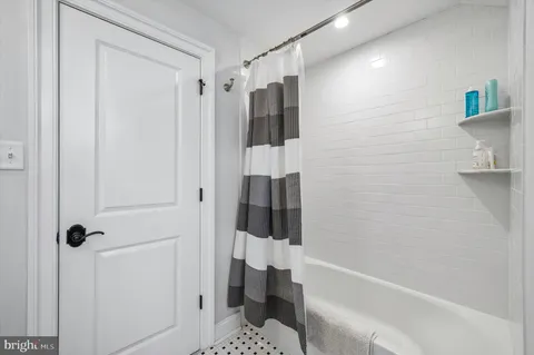 a bathroom with a glass shower door