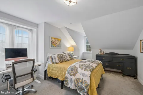 a bedroom with a bed and a chair