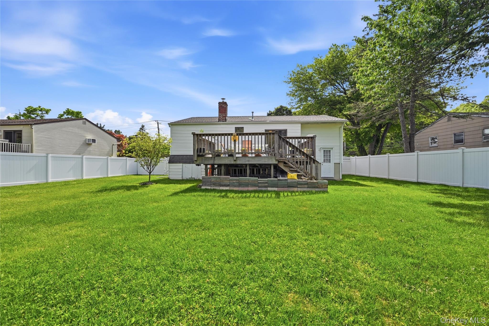 35 Randall Road Shoreham, NY 11786 - Photo 28 of 32 a view of a house with a backyard and a patio
