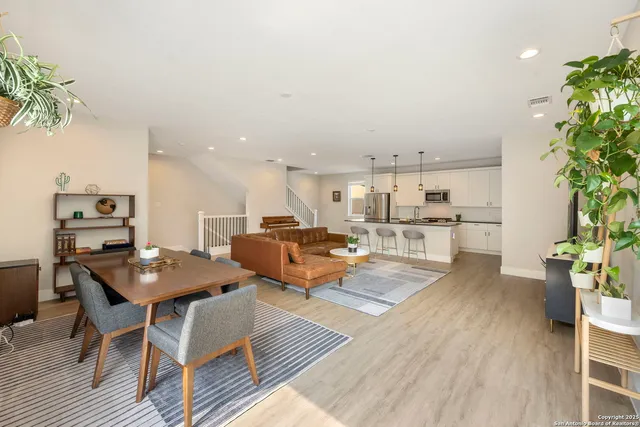 a bathroom with a granite countertop sink a mirror and shower