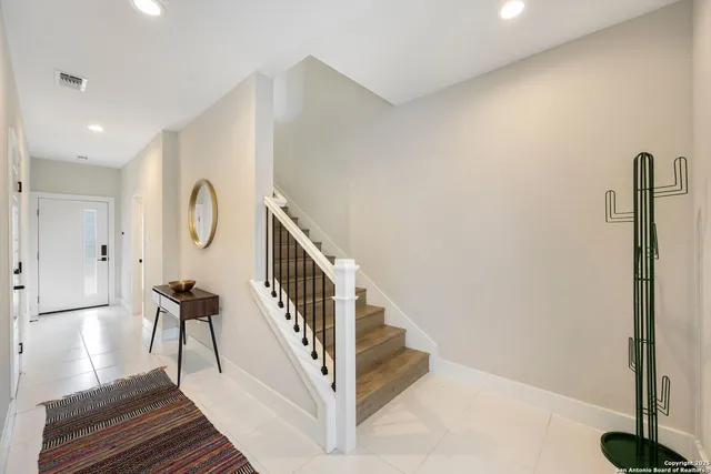 a large living room with stainless steel appliances granite countertop a stove and a wooden floors