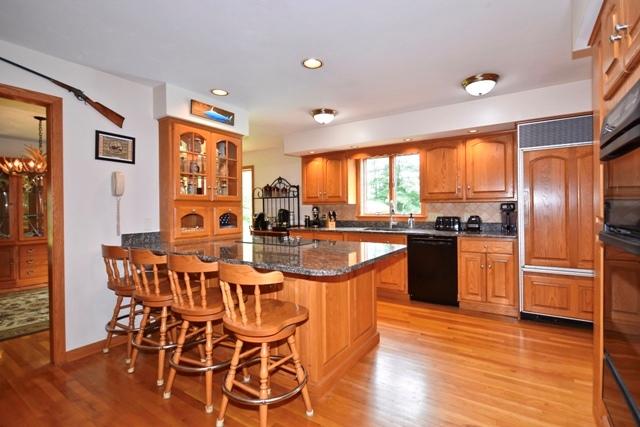 70 Parlowtown Road Rochester, MA 02770 - Photo 4 of 29 a kitchen with stainless steel appliances granite countertop a refrigerator a stove top oven and a dining table with wooden floor