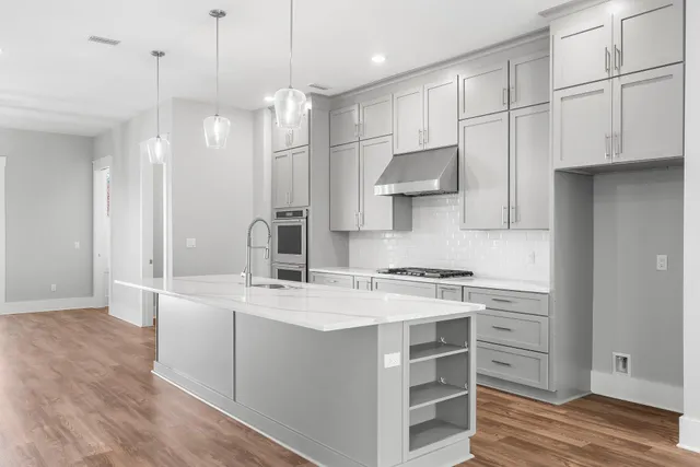 a dining room with furniture a chandelier and wooden floor