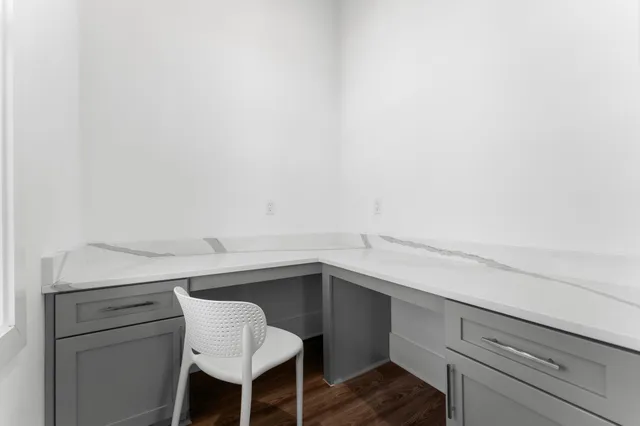 a view of a small space with wooden floor and a window
