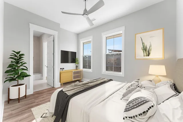 a bathroom with a granite countertop sink toilet a mirror and bathtub