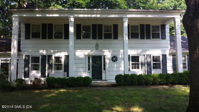 84 Perkins Road Greenwich, CT 06830 - Photo 1 of 11 a view of a brick house with a large windows and a yard in front of it