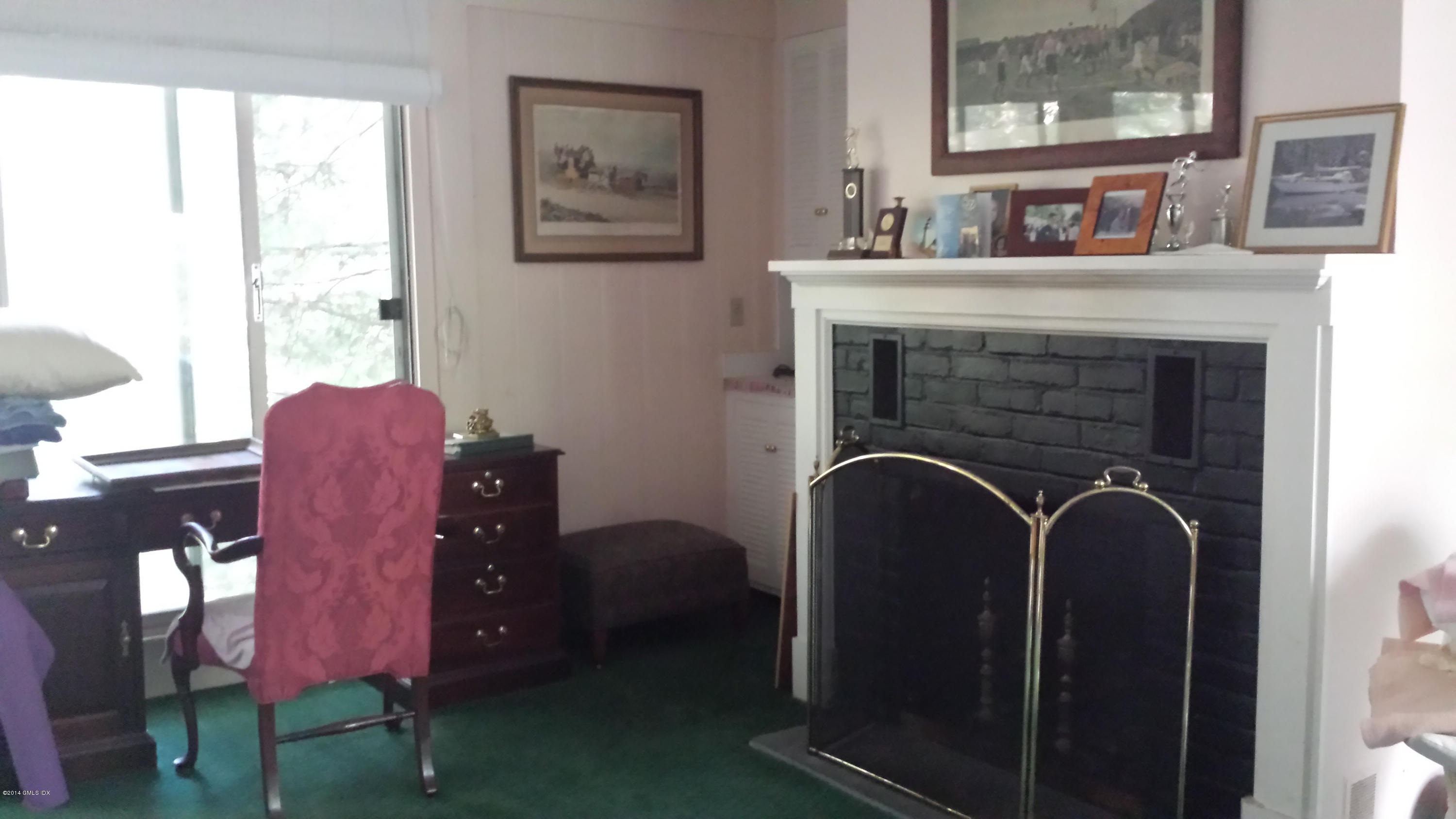 84 Perkins Road Greenwich, CT 06830 - Photo 4 of 11 a living room with furniture and a fireplace