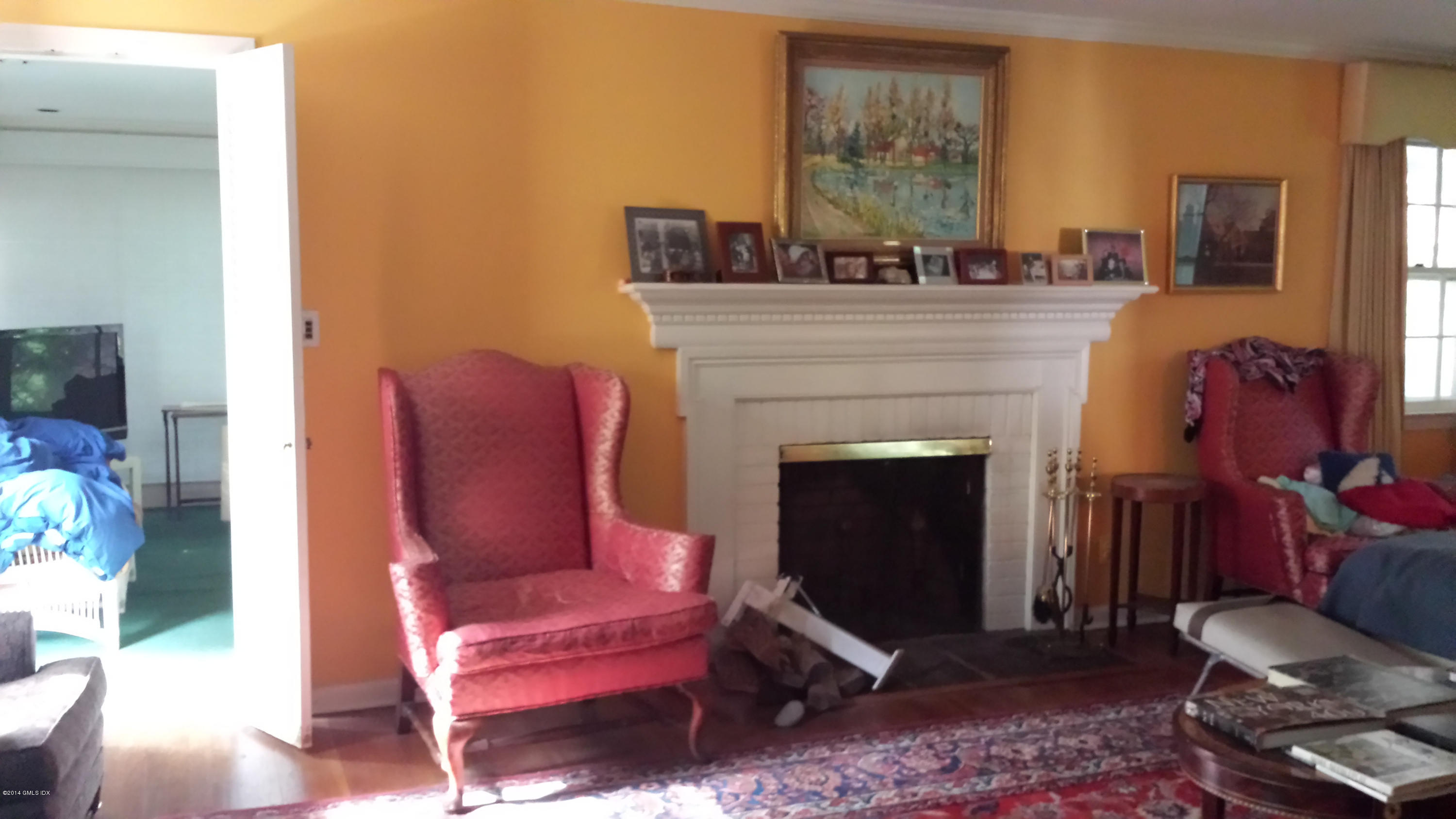 84 Perkins Road Greenwich, CT 06830 - Photo 5 of 11 a living room with furniture and a fireplace
