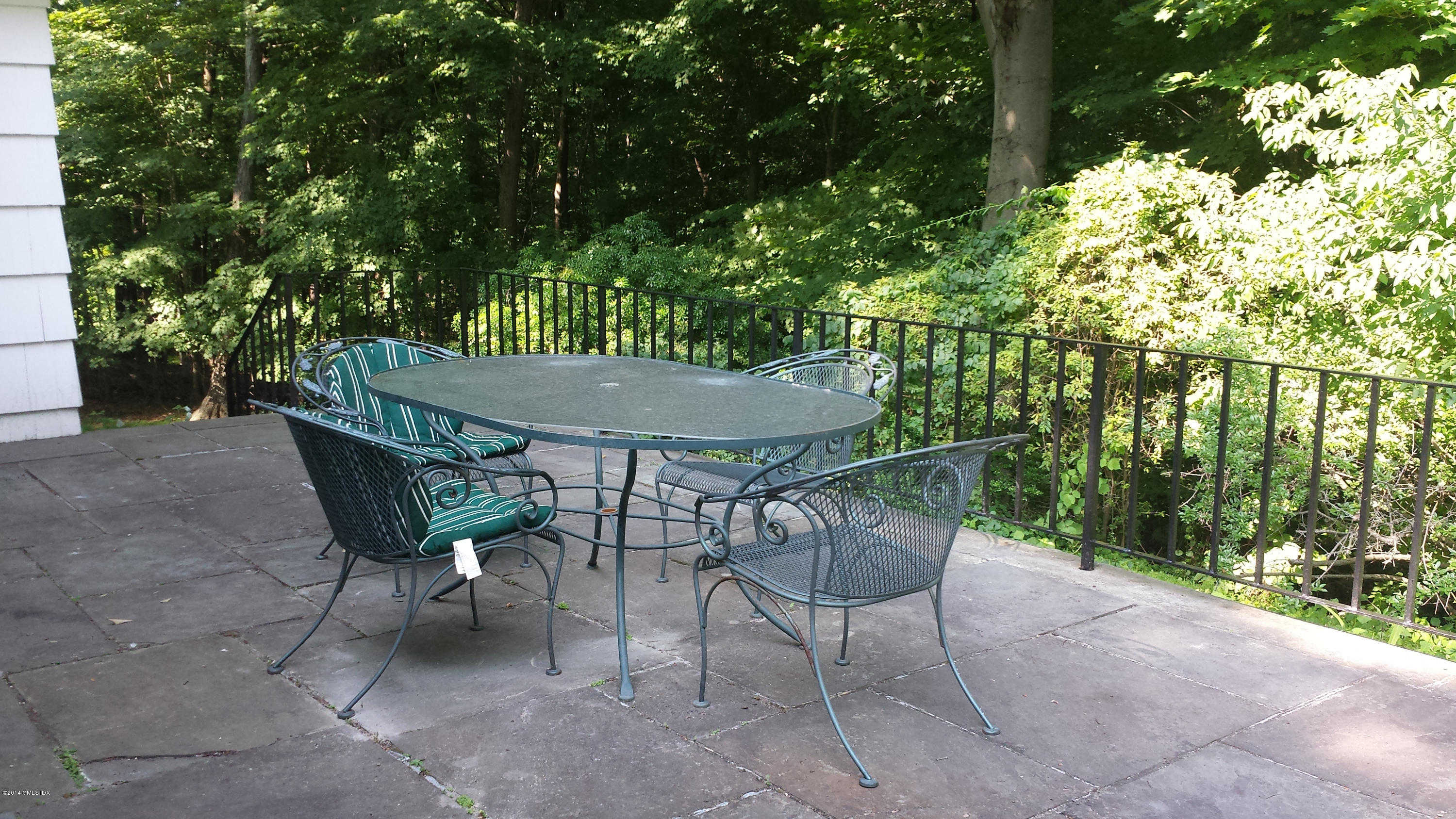 84 Perkins Road Greenwich, CT 06830 - Photo 6 of 11 a patio with table and chairs and potted plants