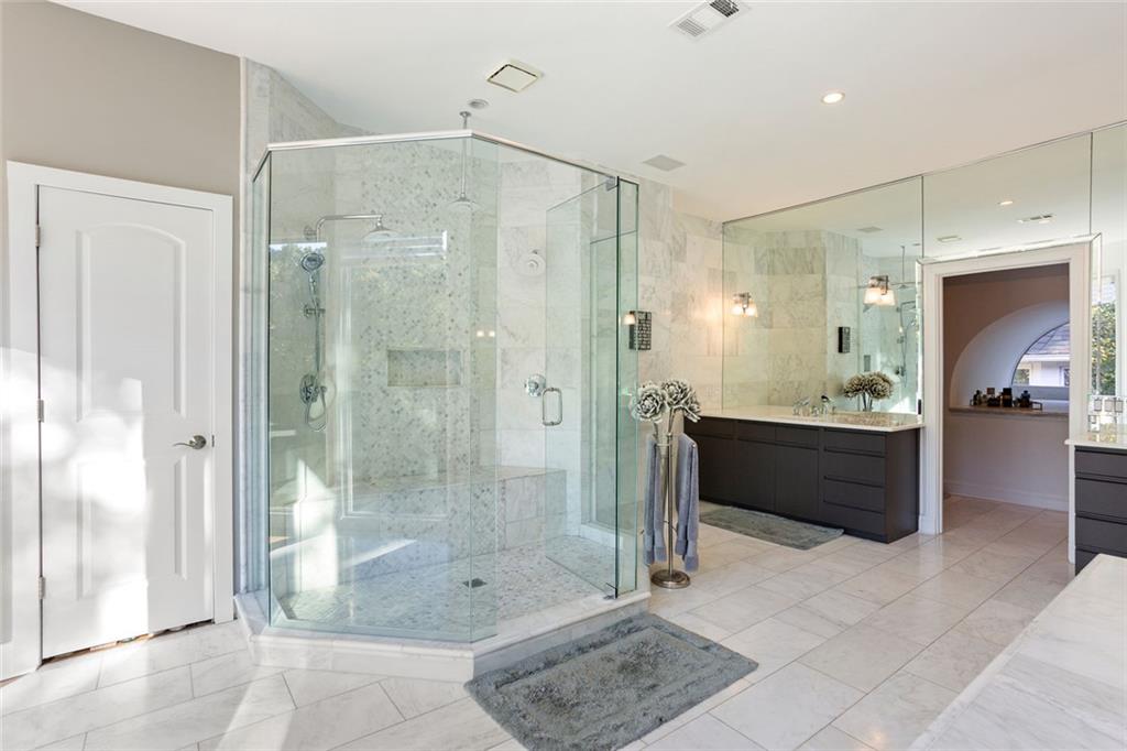 3906 Paces Ferry Road Northwest Atlanta, GA 30327 - Photo 29 of 69 a bathroom with a shower sink and mirror