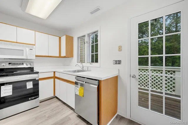 a kitchen with a stove a sink and a microwave