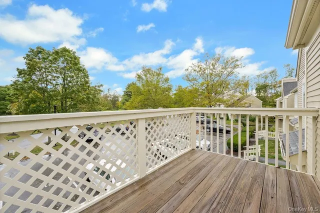 a balcony with wooden floor and fence