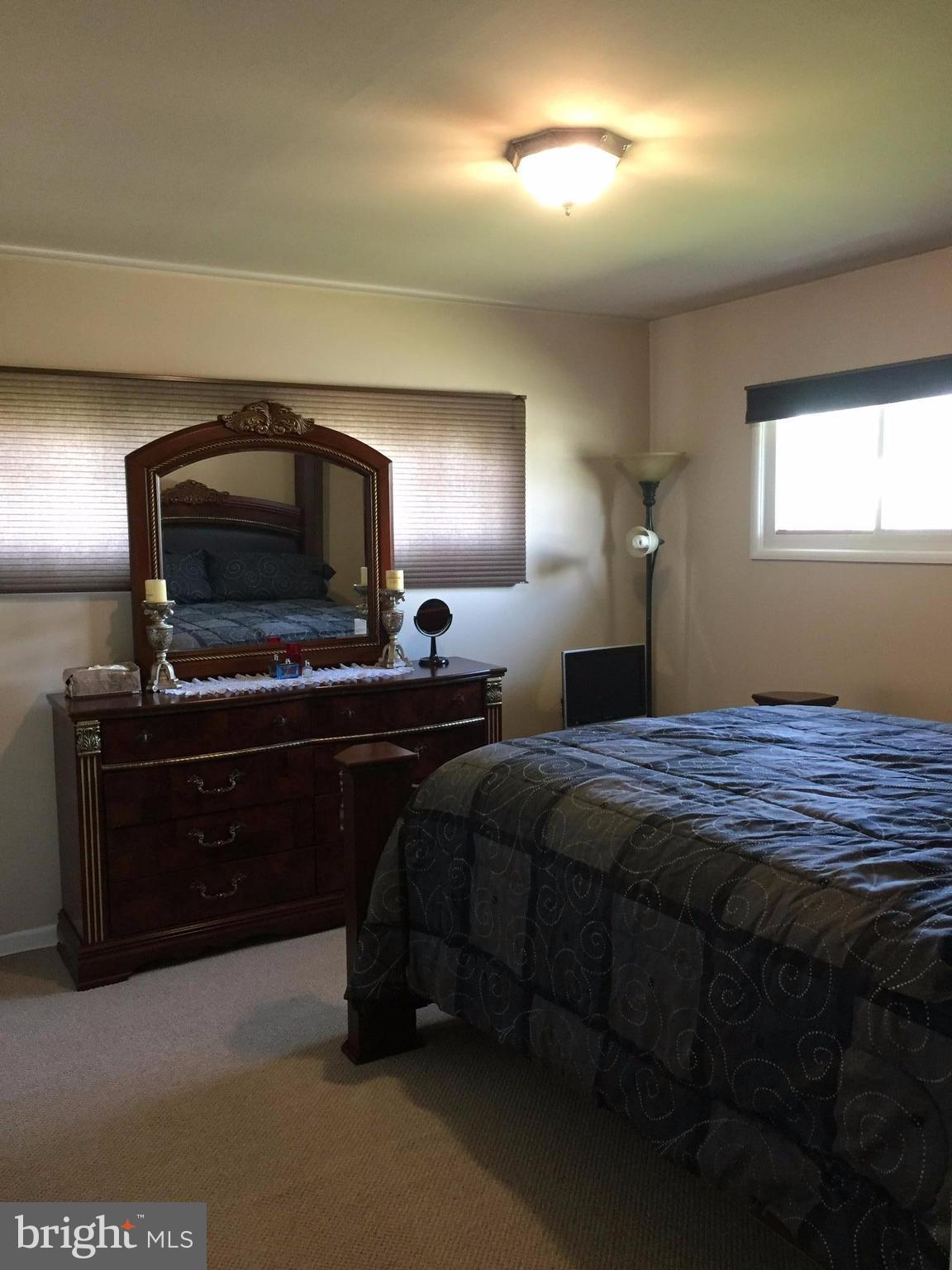 5931 Robindale Road Baltimore, MD 21228 - Photo 7 of 12 a bedroom with bed and a tv