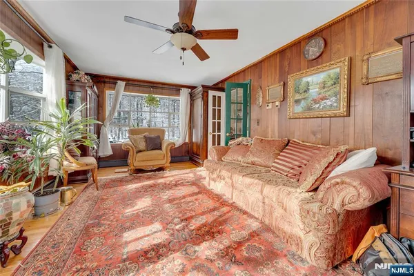 a bedroom with furniture and a large window