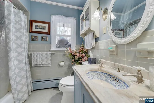 a bathroom with a granite countertop toilet a sink and a mirror