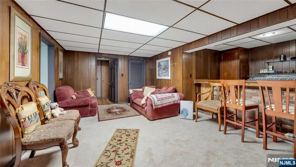 a living room with furniture and wooden floors
