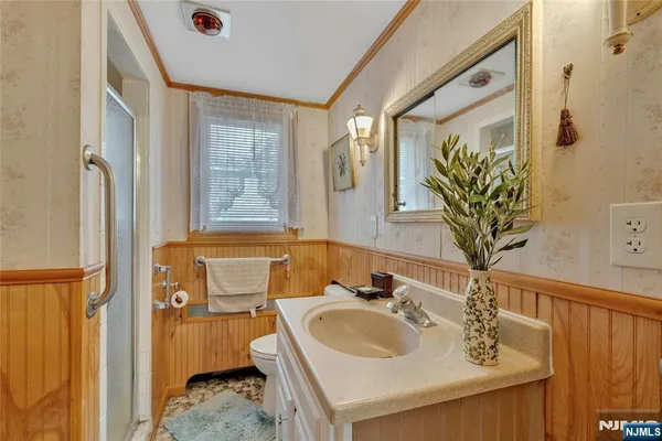 a bathroom with a sink a toilet and a mirror