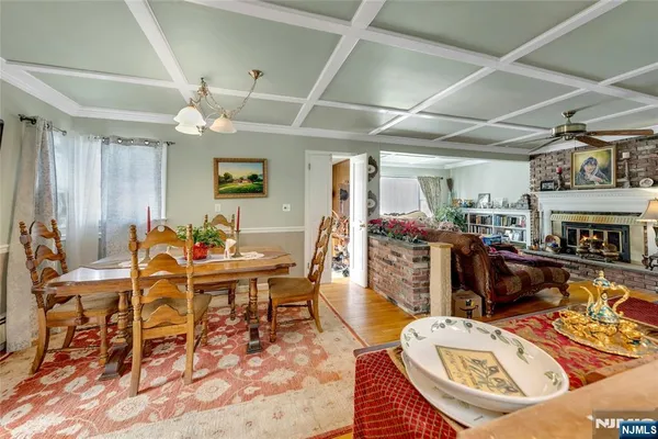 a living room with furniture a fireplace and a chandelier