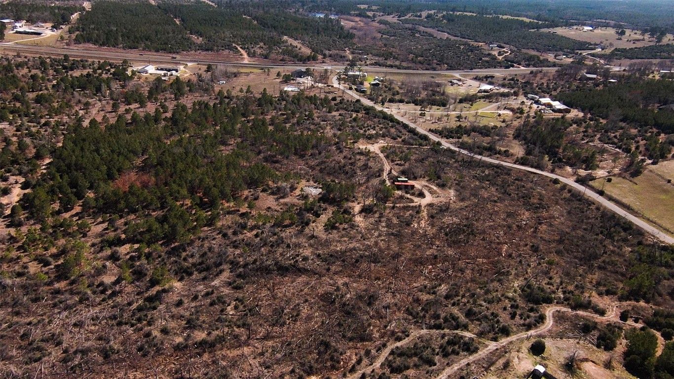 488 Kelley Road East Bastrop, TX 78602 - Photo 32 of 36 an aerial view of residential house with parking space and parking space