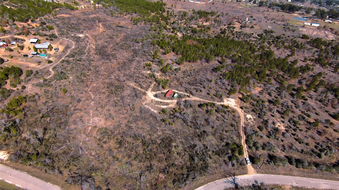 488 Kelley Road East Bastrop, TX 78602 - Photo 33 of 36 a backyard of a house with lots of green space