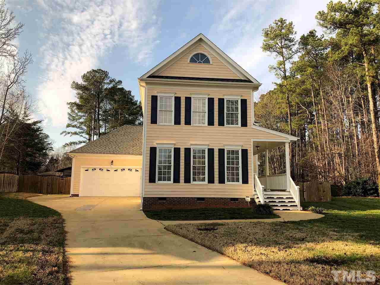 2401 Carruthers Court Raleigh, NC 27615 - Photo 1 of 25 a view of a white house with a small yard and large trees