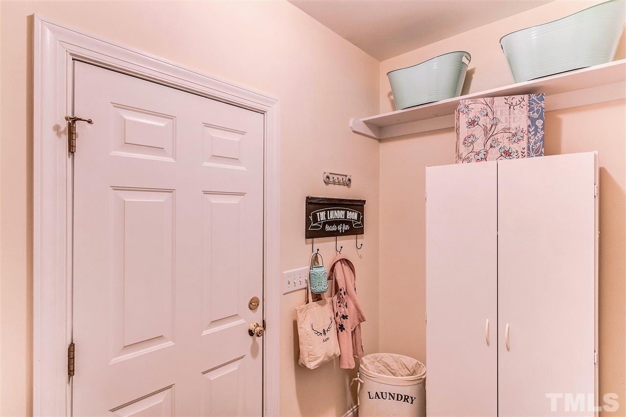2401 Carruthers Court Raleigh, NC 27615 - Photo 11 of 25 a bathroom with a shower curtain