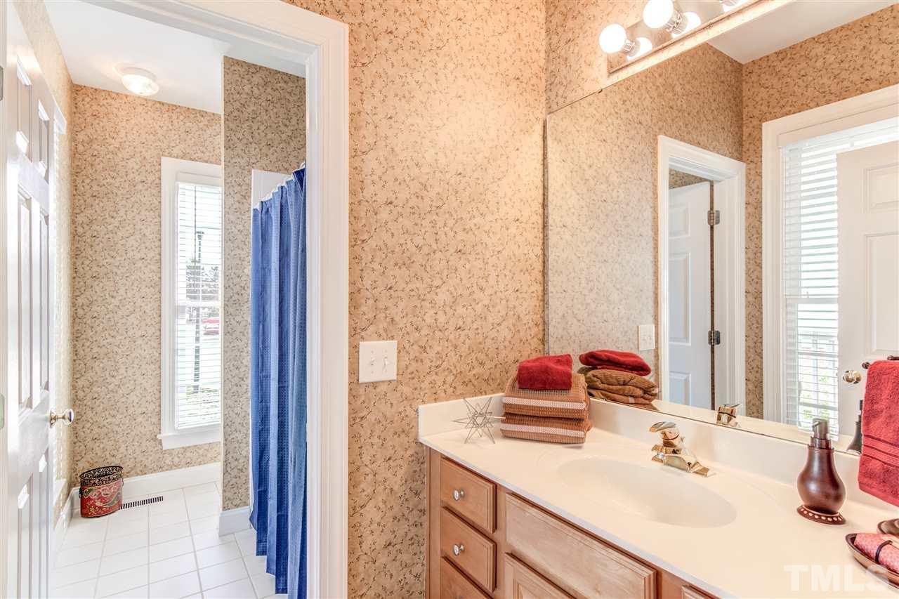 2401 Carruthers Court Raleigh, NC 27615 - Photo 12 of 25 a bathroom with a sink vanity and a mirror