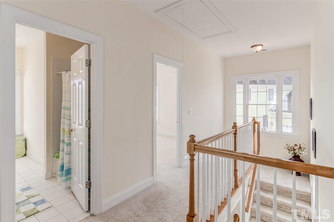 2401 Carruthers Court Raleigh, NC 27615 - Photo 14 of 25 a view of a hallway with wooden floor and windows