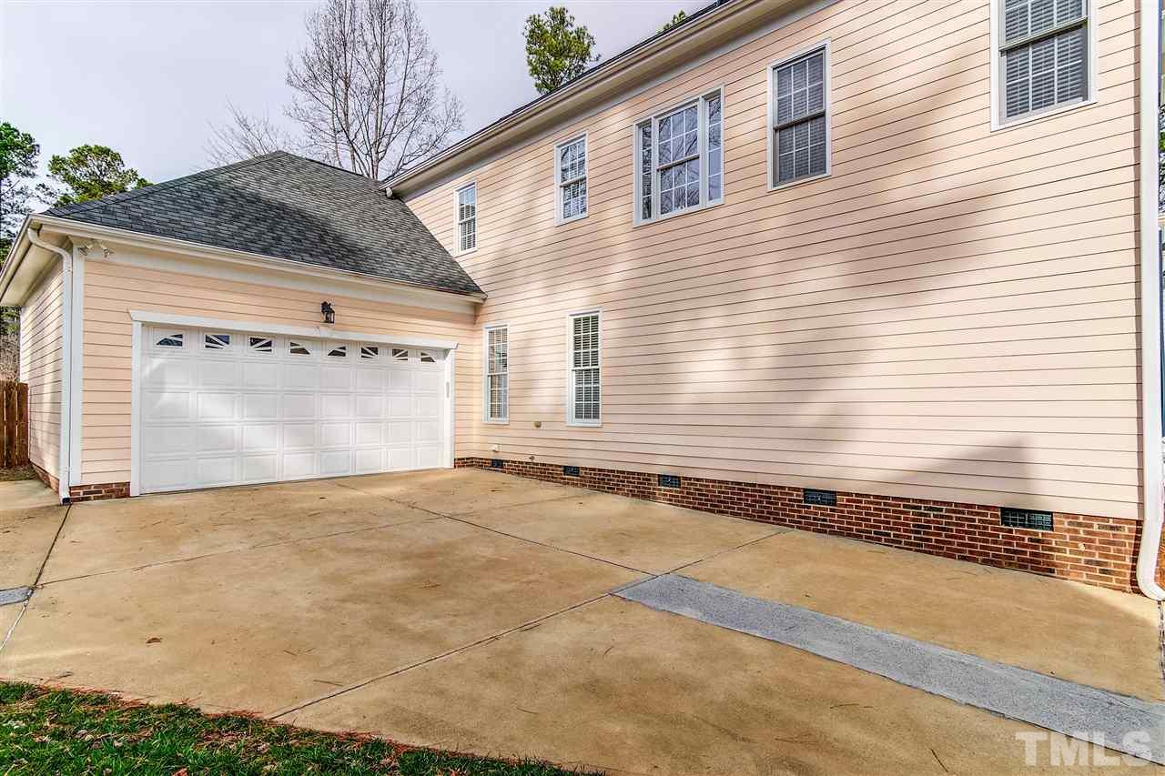 2401 Carruthers Court Raleigh, NC 27615 - Photo 24 of 25 a view of a backyard with a large tree