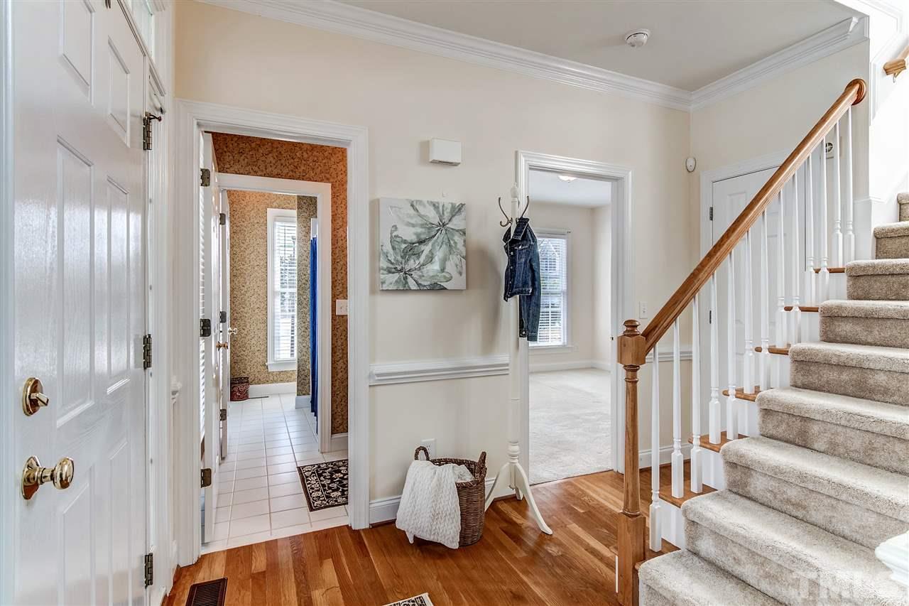 2401 Carruthers Court Raleigh, NC 27615 - Photo 4 of 25 a view of entryway and hall with wooden floor