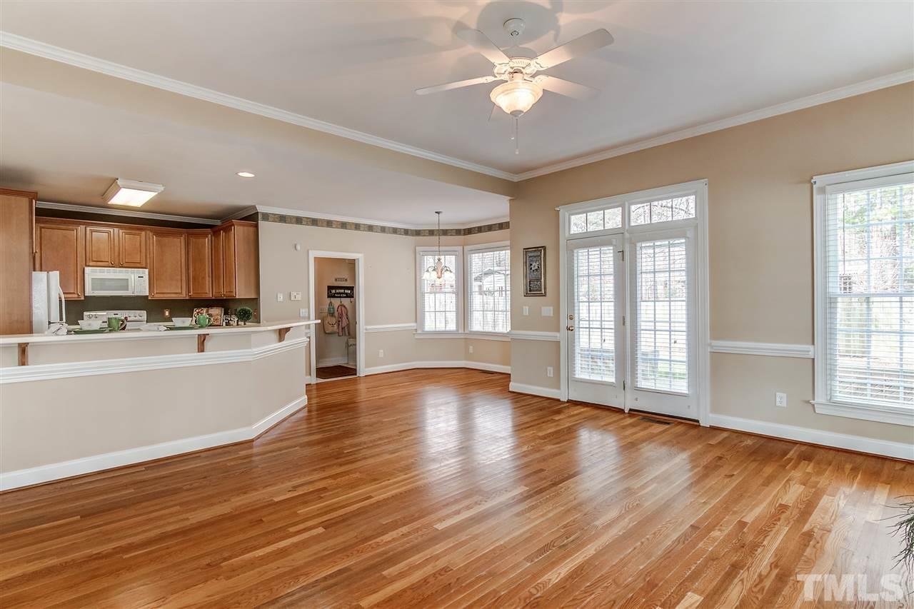 2401 Carruthers Court Raleigh, NC 27615 - Photo 8 of 25 a view of an empty room with window and wooden floor