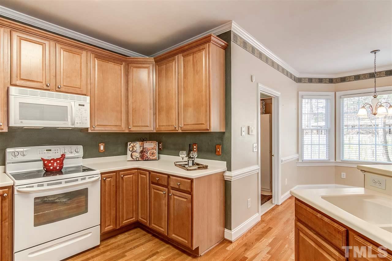 2401 Carruthers Court Raleigh, NC 27615 - Photo 10 of 25 a kitchen with a sink stove top oven and cabinets