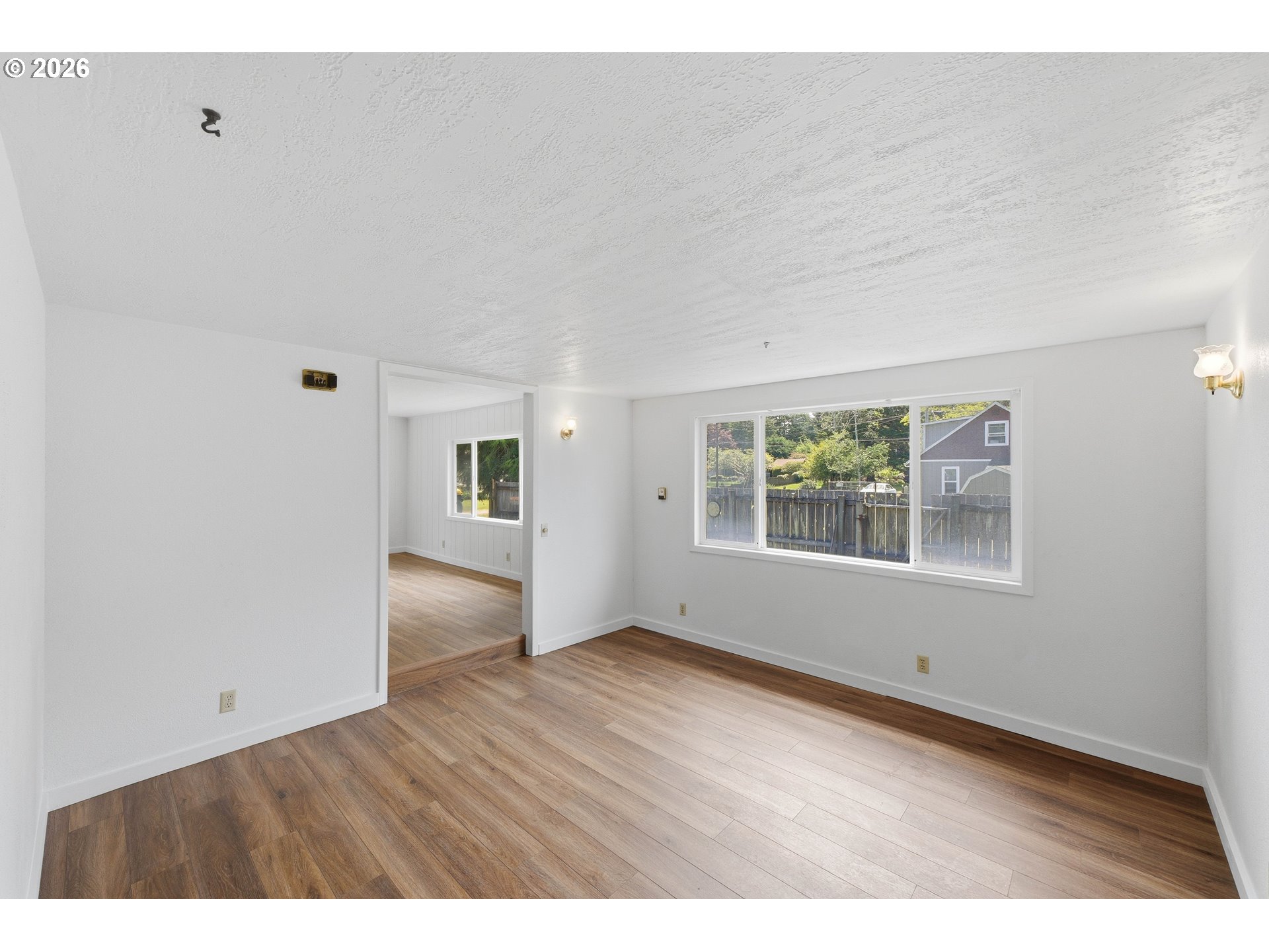 63299 Wildahl Road Coos Bay, OR 97420 - Photo 15 of 45 a view of an empty room with wooden floor and a window