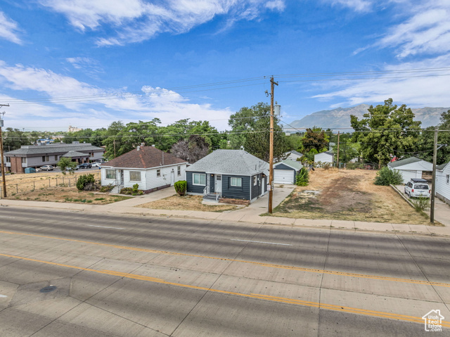 260 36th Street Ogden, UT 84401 - Photo 6 of 15 Bungalow-style house featuring a residential view, a detached garage, driveway, a shingled roof, and an outbuilding