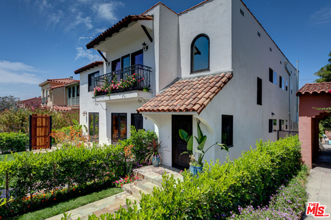 a front view of a house with garden